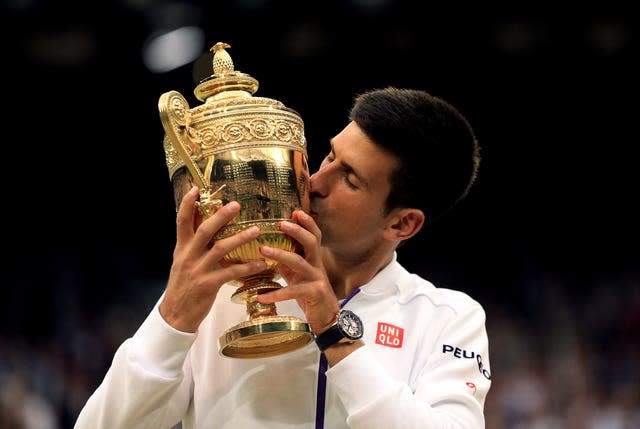 Novak Djokovic kisses the Wimbledon trophy after his 2015 win