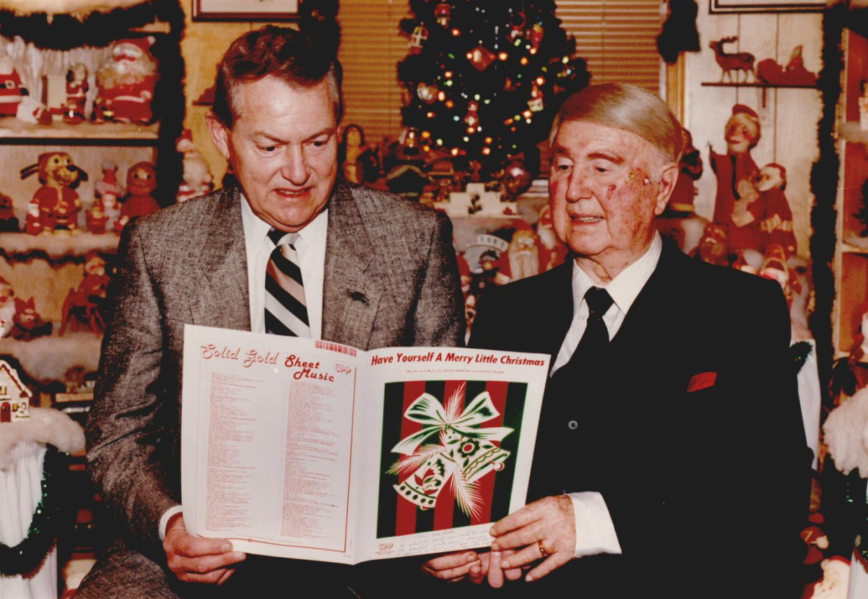 Oklahoma entertainers Ridge Bond, left, and Ralph Blane look over a copy of "Have Yourself A Merry Little Christmas." Blane co-wrote the song in 1944.