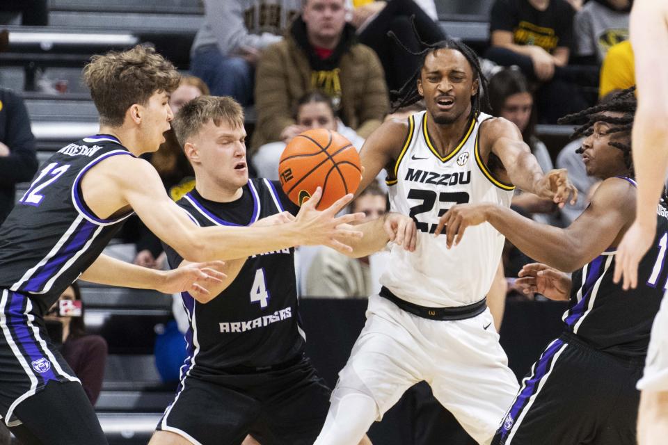 Central Arkansas' Tucker Anderson, from left, Johannes Kirsipuu, Missouri's Aidan Shaw and Carl Daughtery Jr., right, battle for a loose ball during the first half of an NCAA college basketball game Saturday, Dec. 30, 2023, in Columbia, Mo. (AP Photo/L.G. Patterson)