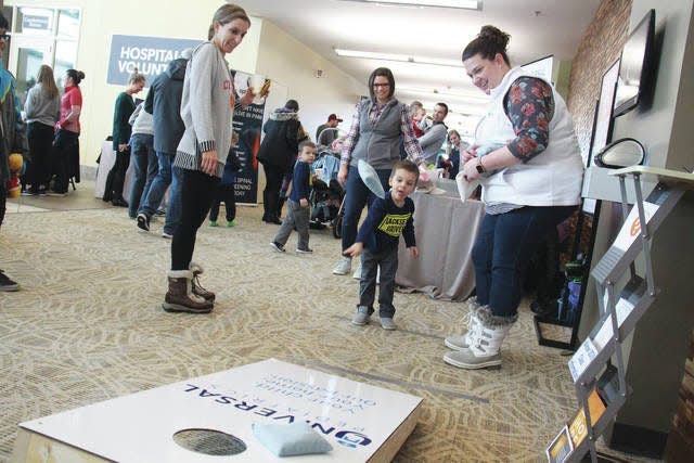 Kids throw bean bags at one of the stations during a past Waukee FamilyFest.