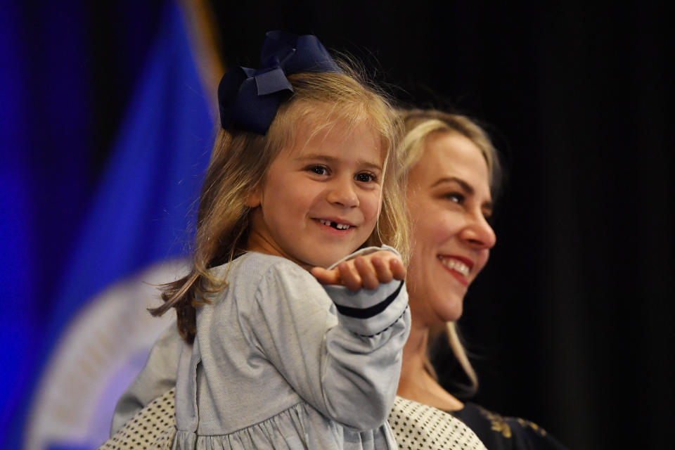 4-year-old Greta McGarvey blows kisses to the crowd as her mother Chris holds her while her father, Democrat Morgan McGarvey, speaks to supporters in Louisville, Ky., Tuesday, Nov. 8, 2022, after he won the race for the state's 3rd Congressional District. (AP Photo/Timothy D. Easley)