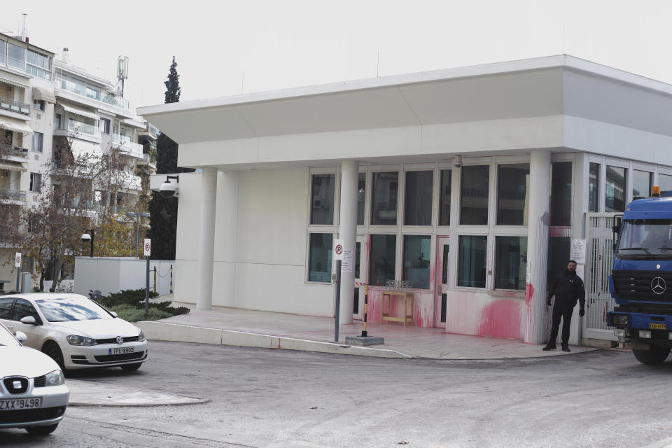 A security staff stands near the entrance of the US embassy in Greece some hours after an anarchist group threw red paint, in Athens, on Monday, Jan. 7, 2019. Police said Monday that eight were detained after about 10 people on motorbikes threw red paint at the embassy's parking entrance at around 3:30 a.m. local time. An anarchist group known as Rouvikonas claimed responsibility for the attack in an internet post.(AP Photo/Petros Giannakouris)