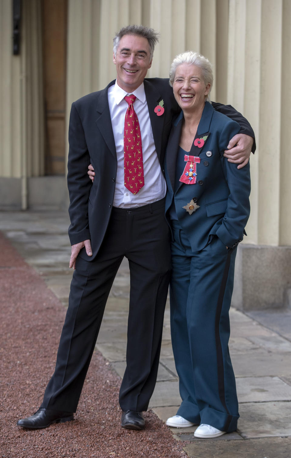 With husband Greg Wise outside Buckingham Palace (Steve Parsons/PA)