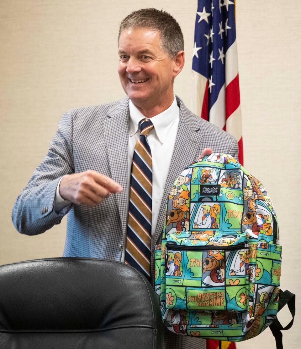 Assistant superintendent Kirk Booe shows off his backpack during a Tippecanoe School Corporation Board of Trustees meeting, Wednesday, Sept. 13, 2023, at the TSC Administration Building in Lafayette, Ind.