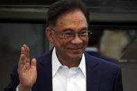 Malaysia opposition leader Anwar Ibrahim waves after a news conference in Kuala Lumpur