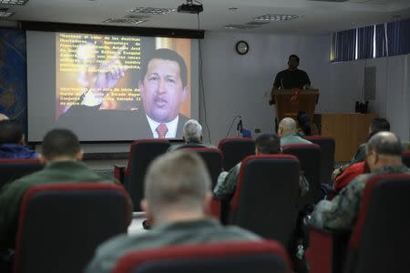 A picture of Venezuela's late President Hugo Chavez is seen during a lecture of the academic course, "Studies of the Thoughts of the Supreme Commander Hugo Chavez" in Caracas November 19, 2014. REUTERS/Carlos Garcia Rawlins