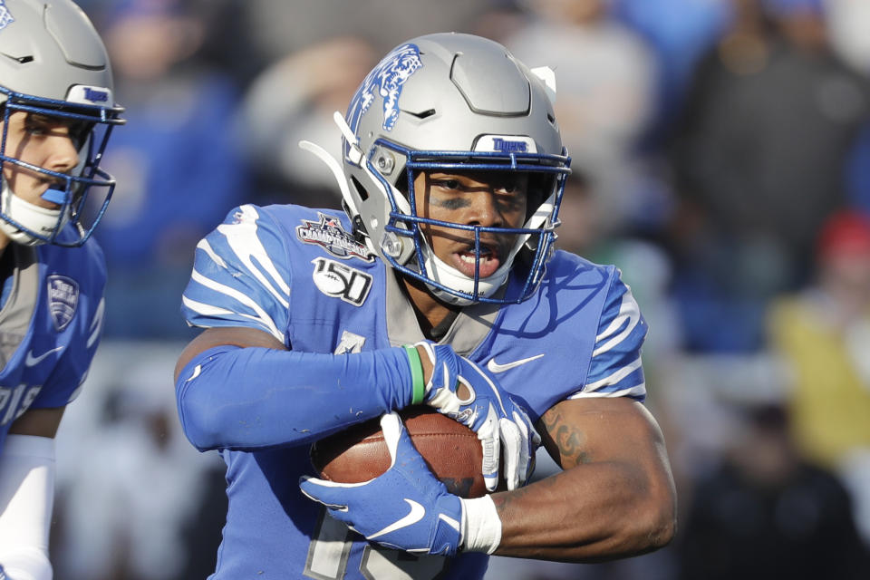 FILE - Memphis running back Kenneth Gainwell carries the ball against Cincinnati during the first half of an NCAA college football game for the American Athletic Conference championship, in Memphis, Tenn., in this Saturday, Dec. 7, 2019, file photo. Gainwell had every intention of playing football with the Memphis Tigers last fall, going through fall practice. The funeral for an uncle, the fourth member of his family to die of COVID-19 made opting out of the season the best decision for Gainwell. (AP Photo/Mark Humphrey, File)