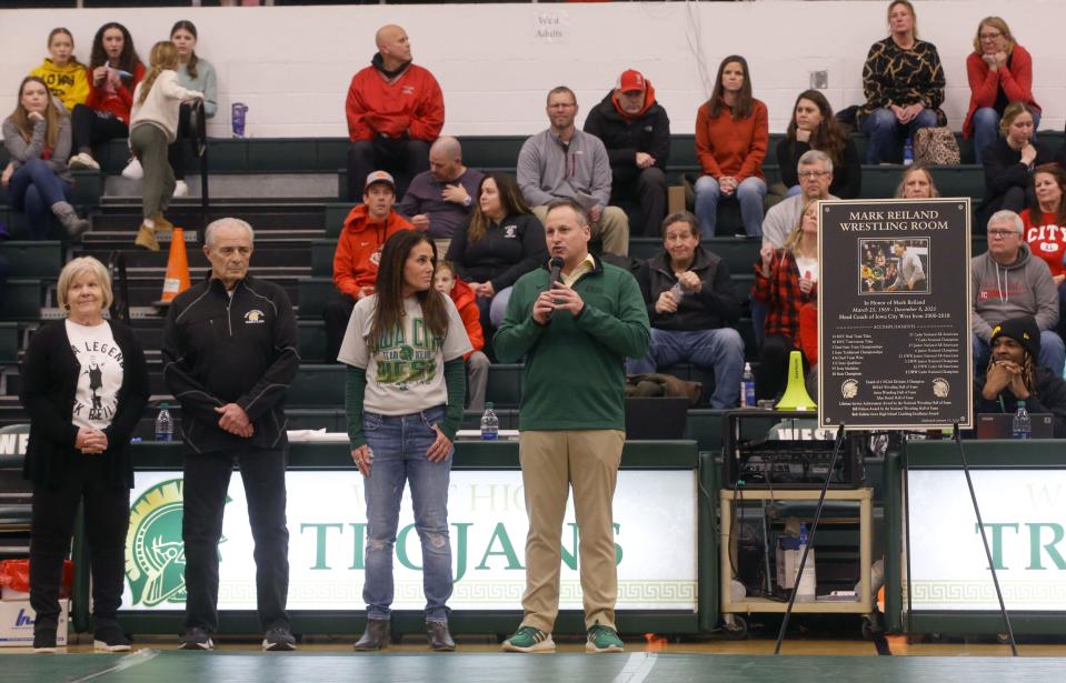 Iowa City West principal Mitch Gross, right, speaks during Thursday's ceremony renaming West's wrestling room after Mark Reiland. Gross was joined by Mark Reiland’s widow Michele and his parents, Marvin and Marlys.