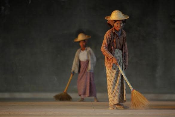 Workers sweep the floor of a newly constructed hotel in capital Naypyitaw, January 24, 2012.