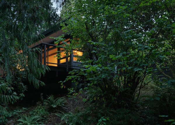 The house is nestled into a wooded ravine, and scarcely visible from the street, giving its owners seclusion even in a highly urban setting just seven miles from Seattle's Space Needle.