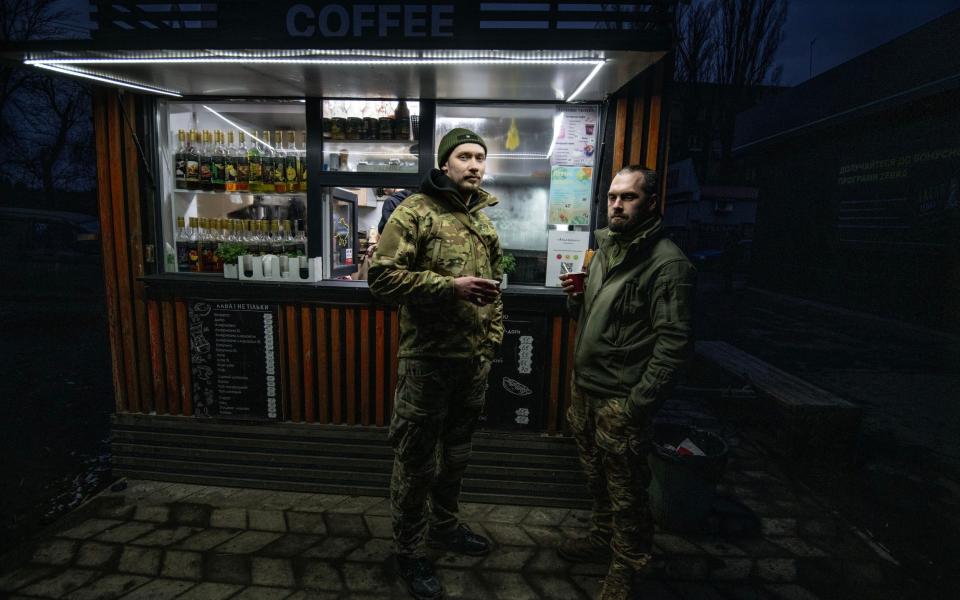 Soldiers 29-year-old Vlad, left and 34-year-old Konstantin drink coffee in the town of Selydova