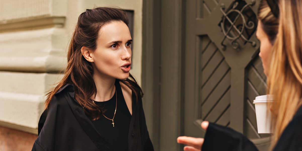 Two women on a city street arguing 