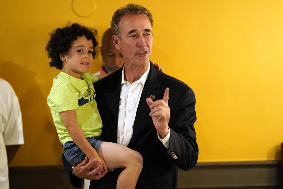 Virginia state Sen. Joe Morrissey holds his son Maverick and he speaks to supporters, Tuesday, Jun. 20, 2023, in Petersburg, Va. Morrissey conceded to former Delegate Lassharese Aird in a Democratic primary for a newly redrawn Senate district. (AP Photo/Steve Helber)