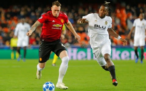 Manchester United's Phil Jones in action with Valencia's Michy Batshuayi - Credit: Reuters