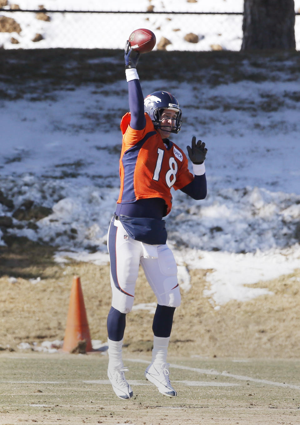 Denver Broncos quarterback Peyton Manning (18) throws a pass at practice for the football team's NFL playoff game against the San Diego Chargers at the Broncos training facility in Englewood, Colo., on Wednesday, Jan. 8, 2014. (AP Photo/Ed Andrieski)