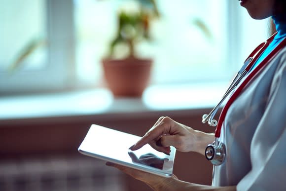 A doctor entering information into a tablet