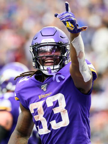 <p>Stephen Maturen/Getty</p> Dalvin Cook points to the crowd after scoring a touchdown in the third quarter of the game against the Atlanta Falcon on September 8, 2019 in Minneapolis, Minnesota.