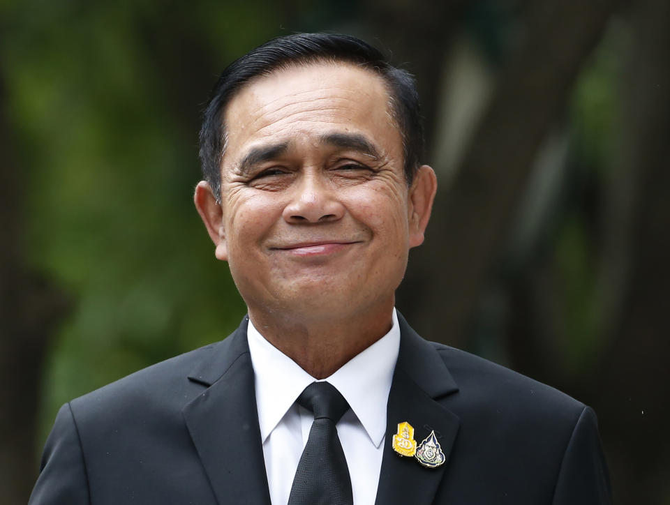 Thailand's Prime Minister Prayuth Chan-ocha smiles as he talks to reporters before meeting at government house in Bangkok, Thailand, Thursday, June 6, 2019. Thailand's Parliament elected 2014 coup leader Prayuth Chan-ocha as prime minister in a vote Wednesday that helps ensure the military's sustained dominance of politics since the country became a constitutional monarchy nearly nine decades ago. (AP Photo/Sakchai Lalit)