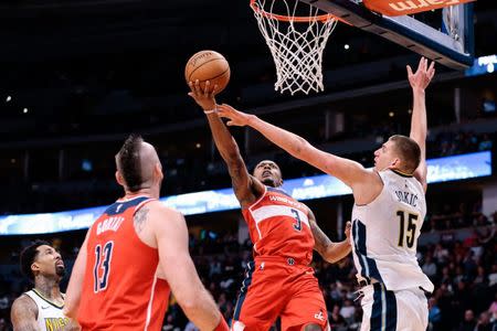 Washington Wizards center Marcin Gortat (13) looks on as guard Bradley Beal (3) attempts a shot while defended by Denver Nuggets center Nikola Jokic (15) in the third quarter. Isaiah J. Downing-USA TODAY Sports