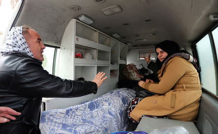 Palestinians gesture as an ambulance transports the dead body of a person, at Rafah border crossing with Egypt, in the southern Gaza Strip January 8, 2019. REUTERS/Ibraheem Abu Mustafa