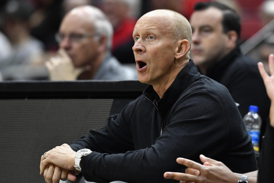 Louisville head coach Chris Mack shouts instructions to his team during an NCAA college basketball scrimmage in Louisville, Ky., Saturday, Oct. 16, 2021. (AP Photo/Timothy D. Easley)