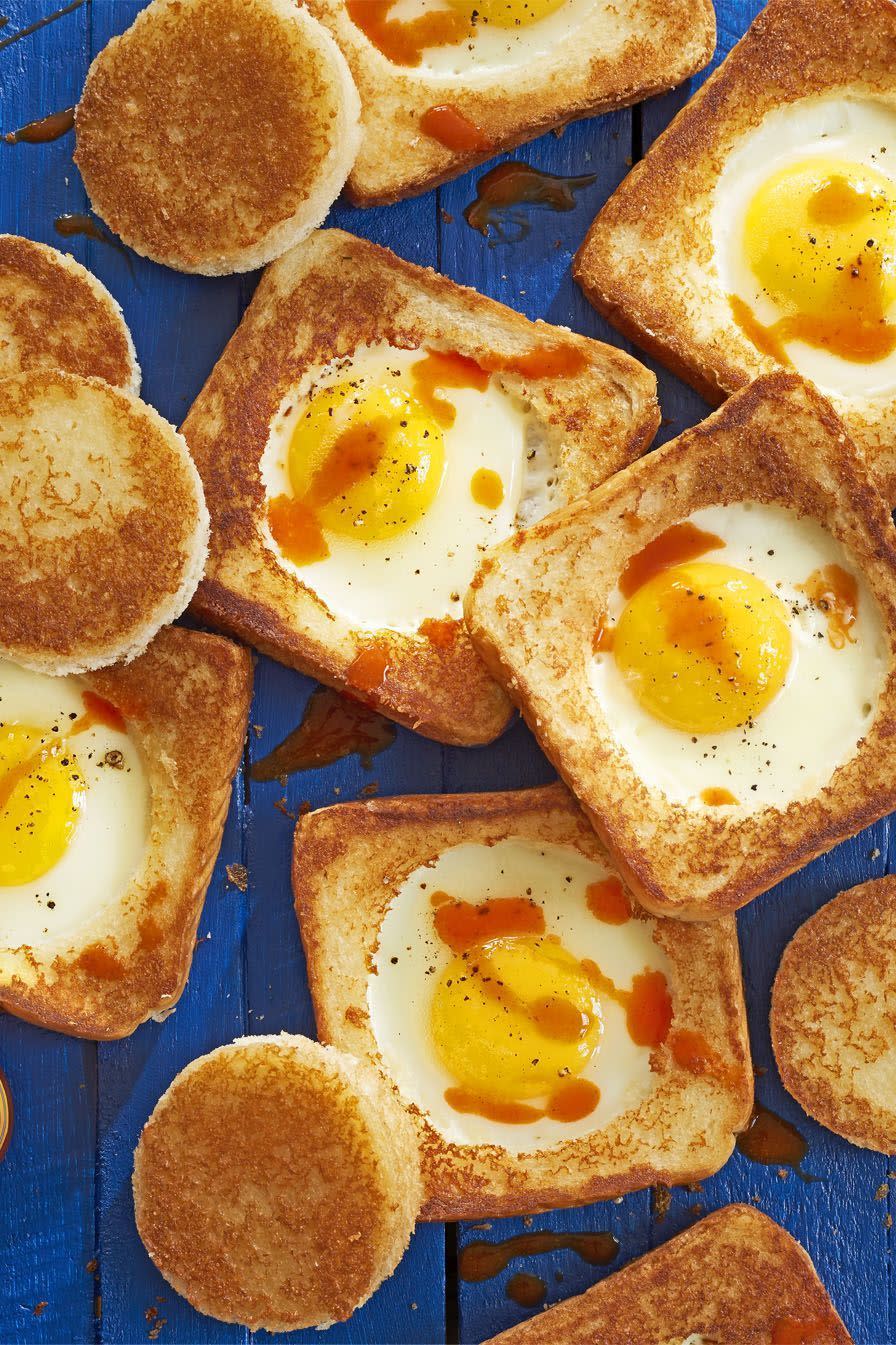white toast with wholes cut out, and and egg cooked in the middle