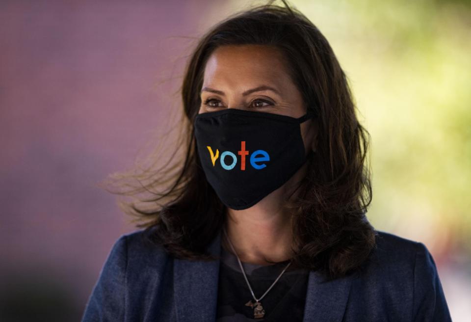 Governor Gretchen Whitmer wears a mask with the word "vote" displayed on the front during a roundtable discussion on healthcare on Wednesday Oct. 7, 2020, in Kalamazoo.