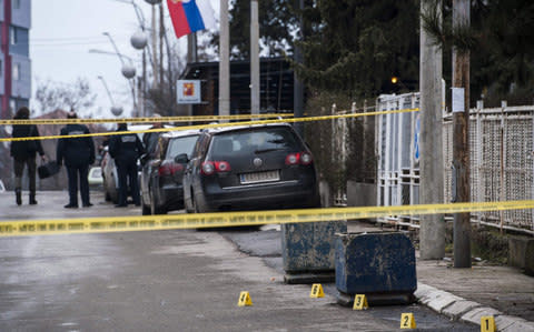 Kosovo police officers secure the area where leading Kosovo Serb politician Oliver Ivanovic was killed in Mitrovica - Credit: ARMEND NIMANI/AFP/Getty Images