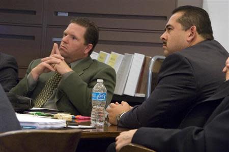 Former Fullerton police officers Jay Cicinelli (L), and Manuel Ramos (R) listen during the trial of Ramos and Cincinelli in Santa Ana, California January 7, 2014. REUTERS/Joshua Sudock/Pool