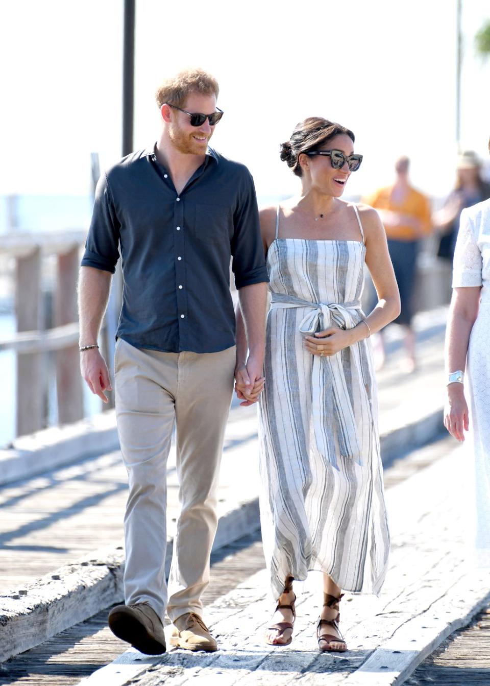 Meghan Markle and Prince Harry stroll hand in hand on Fraser Island.