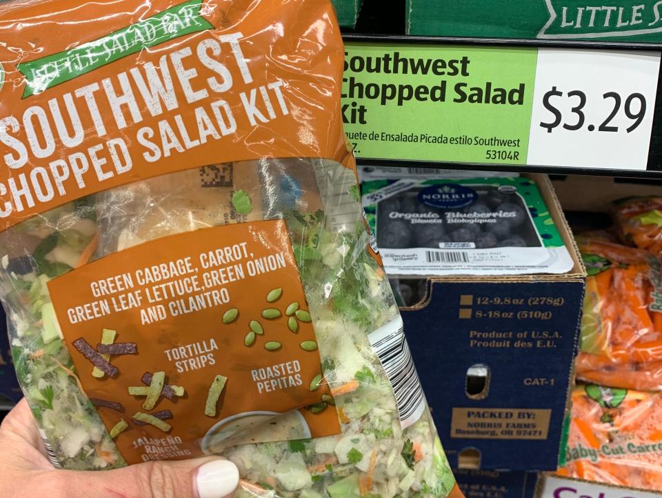 hand holding bag of aldi southwest salad kit