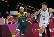 Australia's Patty Mills (5) drives around Italy's Marco Spissu (0) during a men's basketball preliminary round game at the 2020 Summer Olympics, Wednesday, July 28, 2021, in Saitama, Japan. (AP Photo/Eric Gay)
