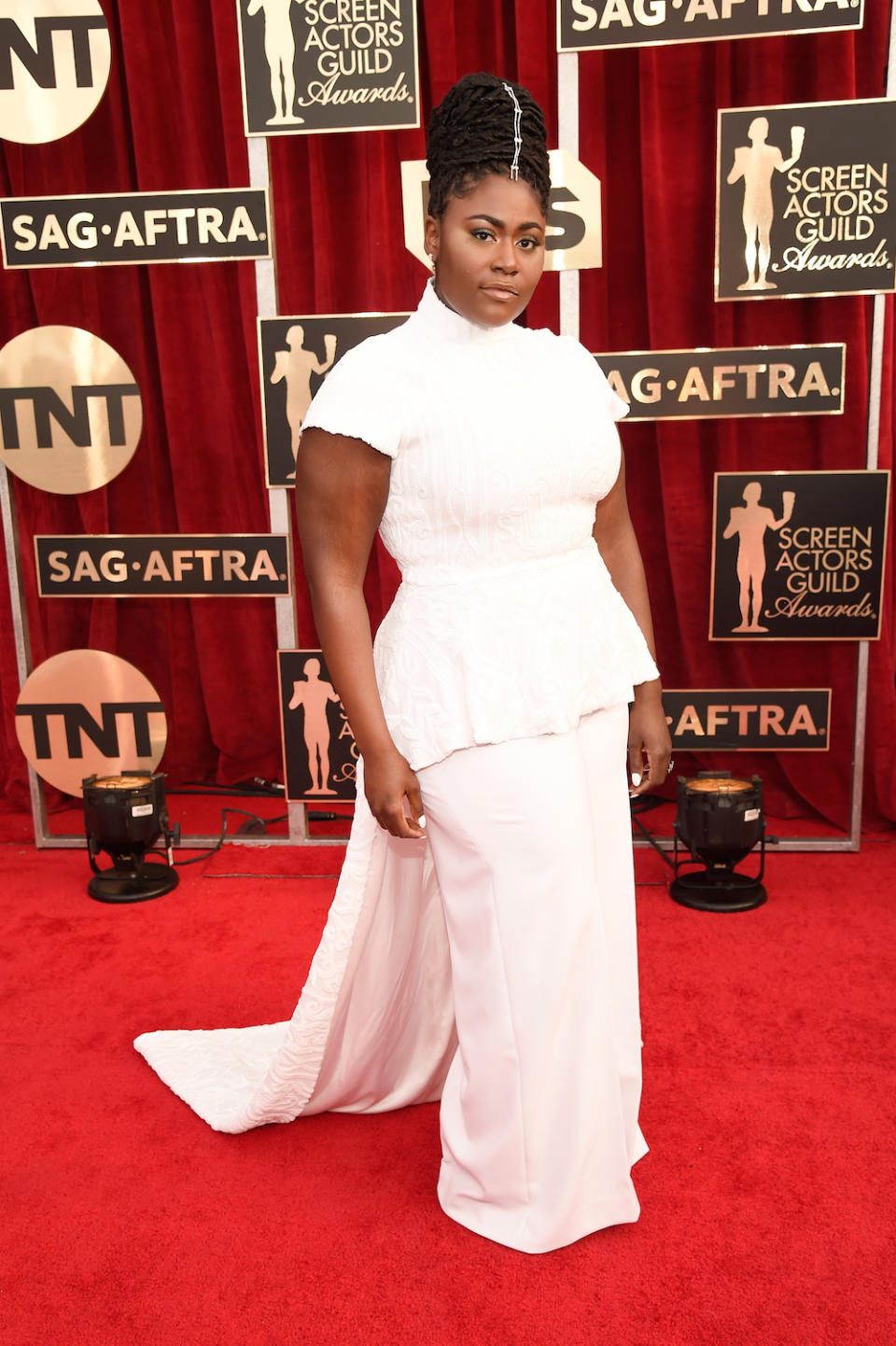 Danielle Brooks paired white pants with a top featuring a train