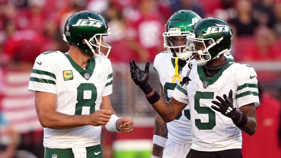 New York Jets quarterback Aaron Rodgers (8) and wide receiver Garrett Wilson (5) talk on the field during the second quarter against the San Francisco 49ers at Levi's Stadium.