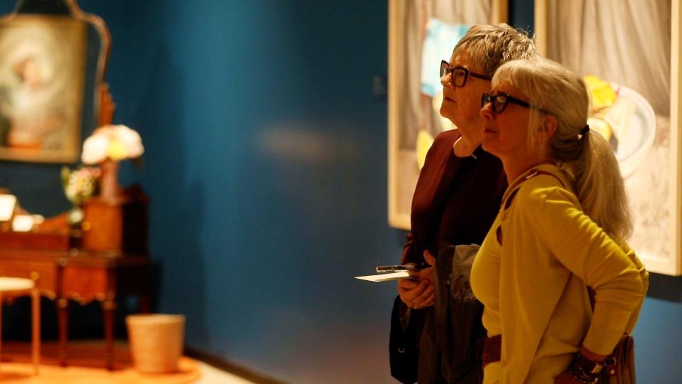 Laraine Kelley of Buffalo and Debby Cambria of Williamsville walk through the exhibit at the Buffalo AKG Art Museum.