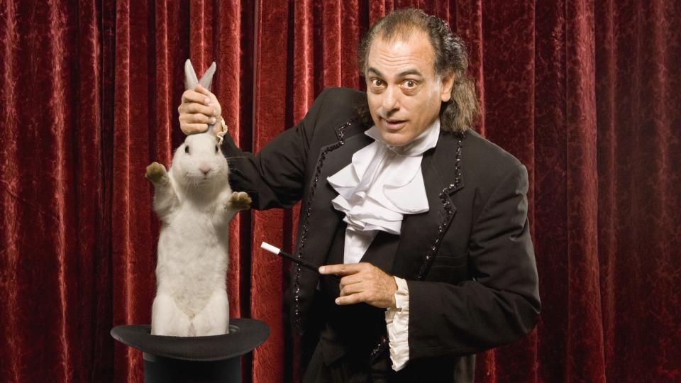  A magician holding a rabbit. 