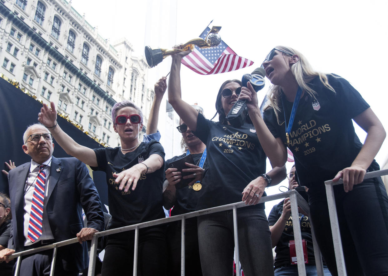 NEW YORK, NY - JULY 10: (L-R) United States Soccer Federation president Carlos Cordeiro, Megan Rapinoe, Ashlyn Harris, Alex Morgan and Allie Long celebrate while riding on a float during The U.S. Women's National Soccer Team Victory Parade and City Hall Ceremony down the Canyon of Heroes on July 10, 2019 in New York City. The team defeated the Netherlands 2-0 Sunday in France to win the 2019 WomenÕs World Cup. (Photo by Debra L Rothenberg/WireImage)