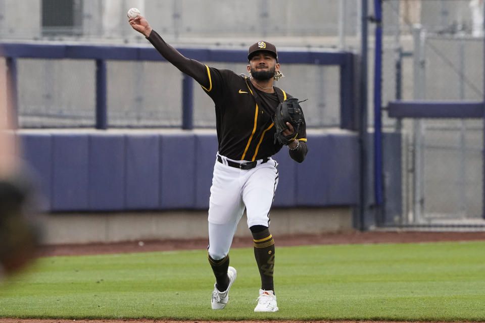 San Diego Padres shortstop Fernando Tatis Jr. throws to first base for the out on a grounder by Cincinnati Reds' Jonathan India during the third inning of a spring training baseball game Tuesday, March 23, 2021, in Peoria, Ariz. (AP Photo/Sue Ogrocki)