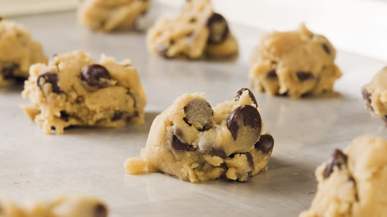 scoops of unbaked cookie dough on baking tray