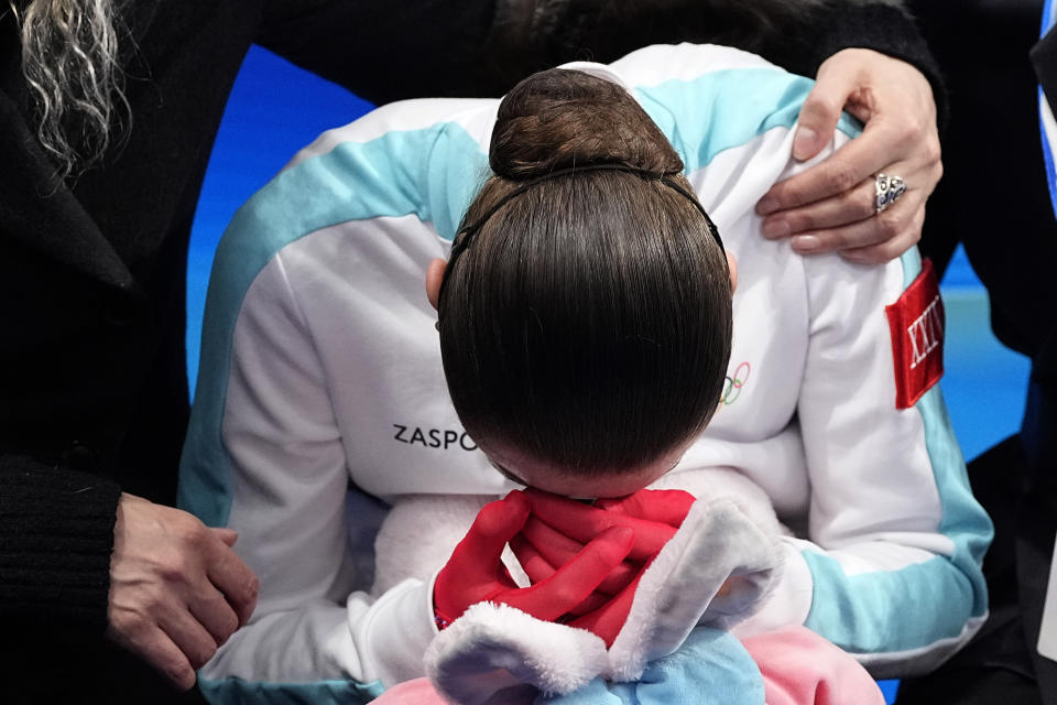 Kamila Valieva, of the Russian Olympic Committee, is consoled by her coach Eteri Tutberidze after competing in the women's free skate program during the figure skating competition at the 2022 Winter Olympics, Thursday, Feb. 17, 2022, in Beijing. (AP Photo/David J. Phillip)