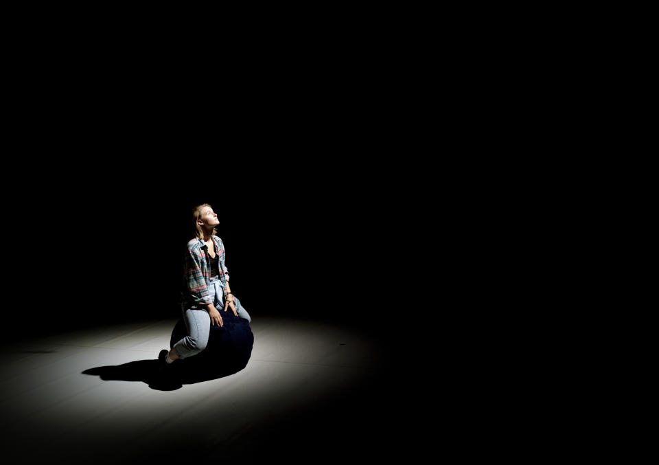 A performer looks up while sitting on the stage of the Trafo House of Contemporary Arts in Budapest, Hungary, Sept. 19, 2022. Theaters and other cultural institutions in Hungary are reeling from exponentially growing energy prices, and some plan to close for the winter to avoid the skyrocketing bills. The Erkel Theatre in the capital of Budapest will close in November after its utilities went up as much as tenfold, and local governments across the country have ordered theaters, cinemas and museums to shut down during the cold months. (AP Photo/Bela Szandelszky)