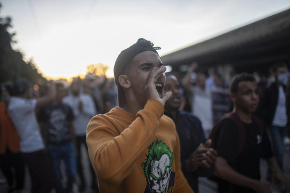 A protester shouts slogans during a demonstration against the government enforcing of a mandatory COVID-19 vaccine pass, in Rabat, Morocco, Sunday, Oct. 31, 2021. (AP Photo/Mosa'ab Elshamy)