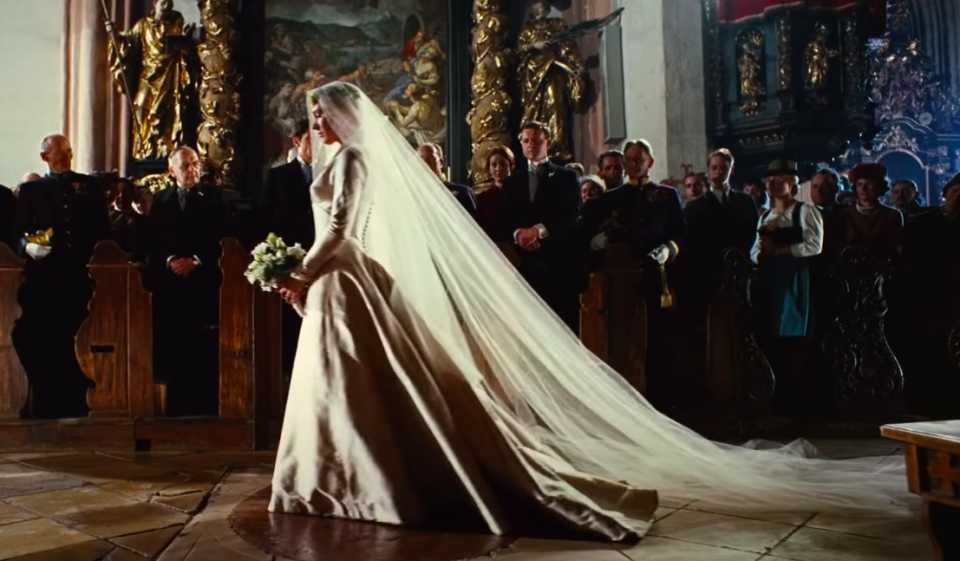 Maria wearing a long-sleeve ballgown with a long veil