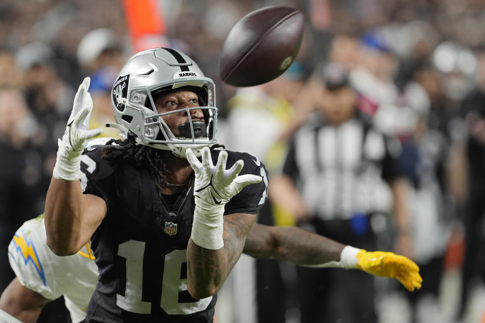 Las Vegas Raiders wide receiver Jakobi Meyers (16) catches a pass for a touchdown against the Los Angeles Chargers during the first half of an NFL football game, Thursday, Dec. 14, 2023, in Las Vegas. (AP Photo/Nick Didlick)