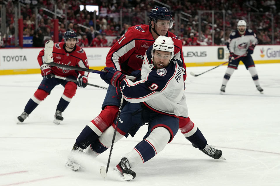 Columbus Blue Jackets defenseman Ivan Provorov (9) gets pressured from Washington Capitals center Aliaksei Protas (21) during the second period of an NHL hockey game in Washington, Saturday, Nov. 18, 2023. (AP Photo/Susan Walsh)