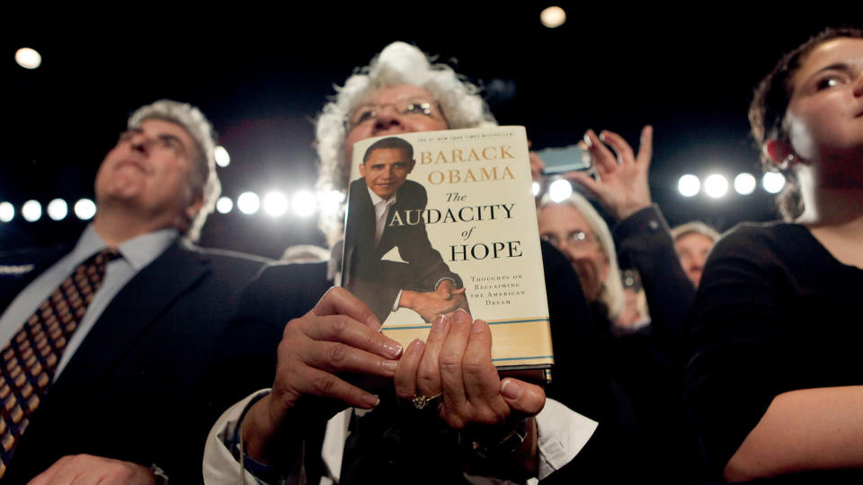 A member of the audience holds a copy of President Barack Obama's book 'The Audacity of Hope' during a fundraiser for Sen.