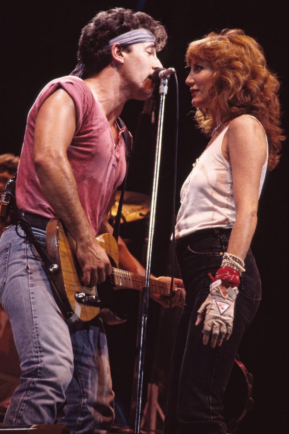 American Rock musicians Bruce Springsteen, on guitar, and backing vocalist Patti Scialfa of the E Street Band, perform onstage during the 'Born in the USA' tour, at Giants Stadium, East Rutherford, New Jersey, August 22, 1985.