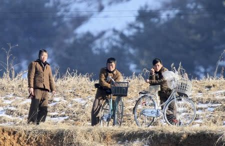 Members of North Korean military rest on their bicycles on the banks of Yalu River, in Sakchu county, North Korea, January 7, 2016. REUTERS/Jacky Chen