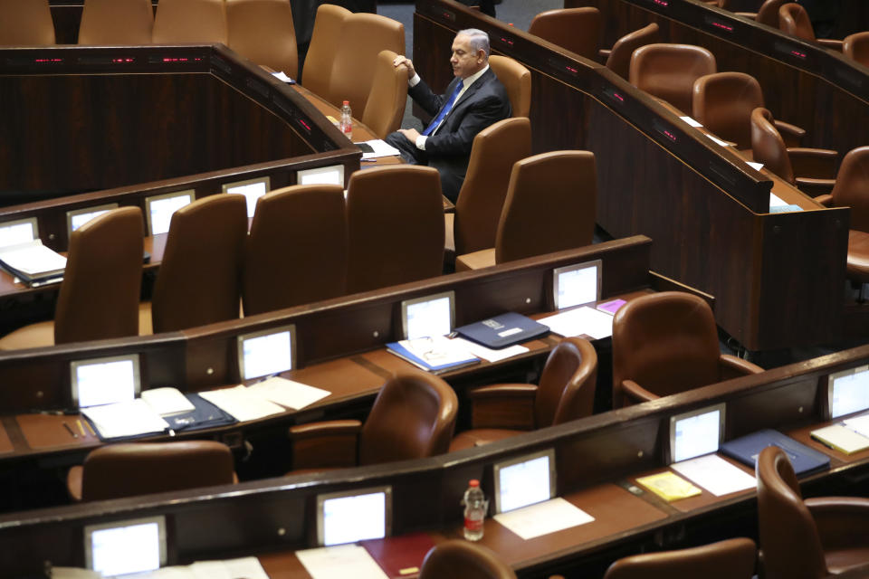 Outgoing Israeli Prime Minister Benjamin Netanyahu sits during a Knesset session in Jerusalem Sunday, June 13, 2021. Naftali Bennett is expected later Sunday to be sworn in as the country's new prime minister, ending Prime Minister Benjamin Netanyahu's 12-year rule. (AP Photo/Ariel Schalit)