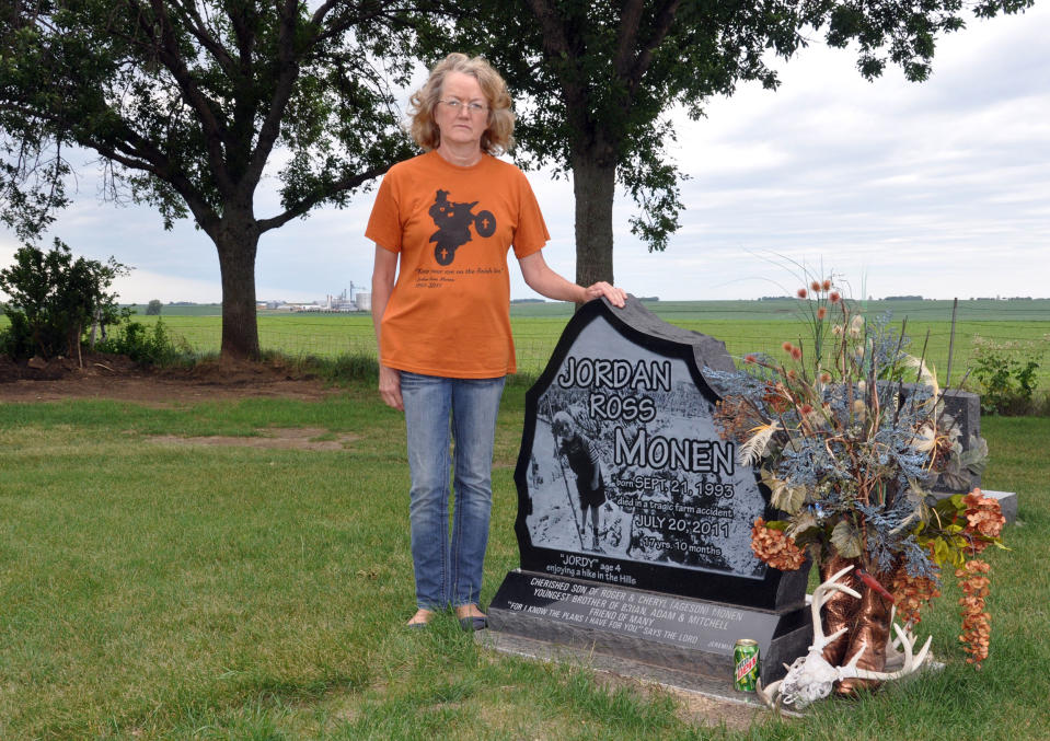 Cheryl Monen stands aside a gravestone for her youngest son, Jordan, who was killed last year in a farm accident, Wednesday, June 20, 2012, in Lester, Iowa. (AP Photo/Dirk Lammers)